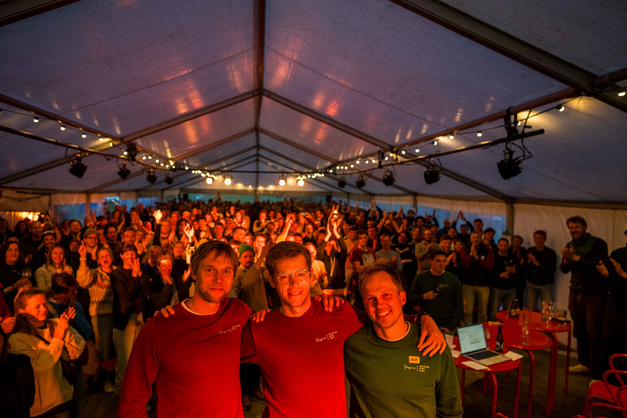 Three organisers in front of the crowd at Belgium Bike Fest
